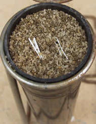 A deepot is filled with presterilized sand and soil mix with buried folded filter